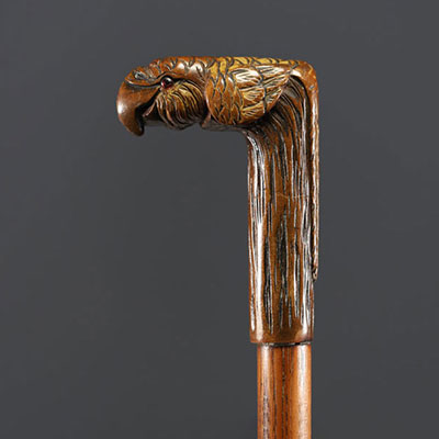 Carved wooden cane with parrot head motif, glass eyes.