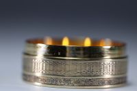 A solid silver snuffbox with a guilloche motif, the lid containing a miniature of flowers.