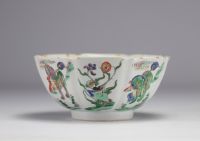 A porcelain bowl decorated with flowers and dogs with a mark under the piece, Kangxi period (1661-1722)