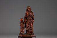 Vierge à l'enfant en buis sur socle en bois noirci, plaquette en os 