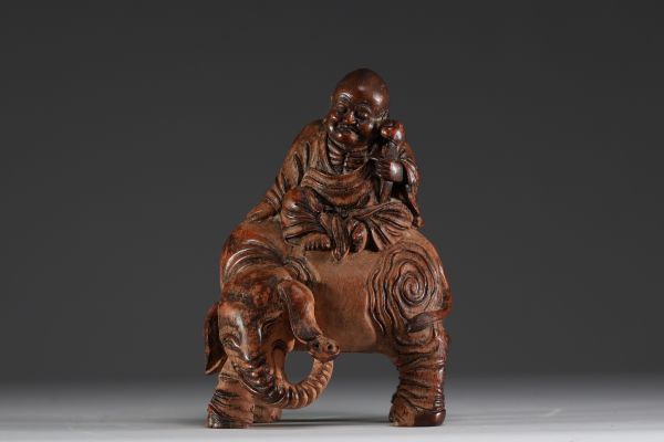 China - Buddha seated on an elephant, sculpture in patinated bamboo.