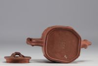 China - Yixing teapot in terracotta with floral decoration in relief, debossed mark on the underside.