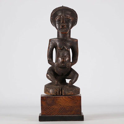 Songye statuette in a special position from Rep. Dem. of Congo