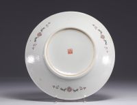 China - Famille rose porcelain plate decorated with figures in a garden, Republic period.