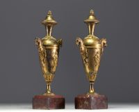 A pair of gilt bronze Directoire period covered vases.