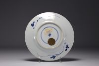 China - A blue-white porcelain plate with floral decoration, Kangxi mark and period.