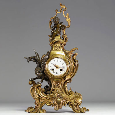 A 19th century ormolu and patinated clock decorated with a Putto and a winged dragon.