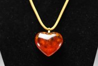 Yves SAINT LAURENT - Heart necklace, imitation amber and gold-plated metal, signed.