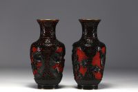 China - A pair of cloisonné vases with figures.