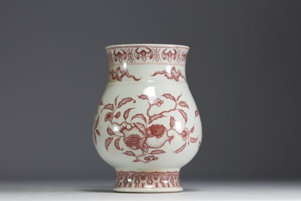 China - Iron-red porcelain vase decorated with fruit and bats, blue mark.