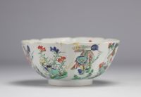 A porcelain bowl decorated with flowers and dogs with a mark under the piece, Kangxi period (1661-1722)