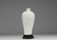 China - An 18th century celadon porcelain vase decorated with flowers in relief.