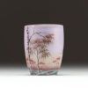 DAUM Nancy - Vase miniature en verre multicouche dégagé à l'acide et émaillé à décor de paysage lacustre et de bouleaux, signé sous la base.