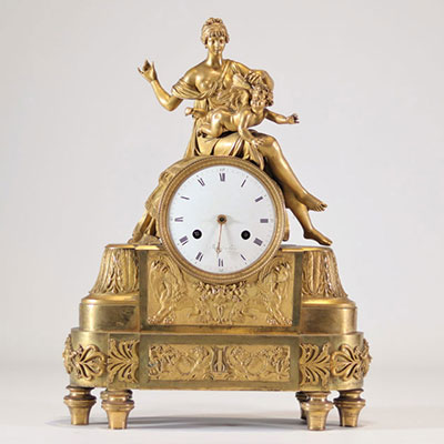 Beautiful gilt bronze clock decorated with a naked young woman and an Empire style angel