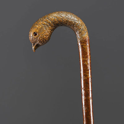 Carved wooden cane with bird's head motif, glass eyes.