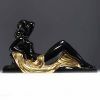 Charles LEMANCEAU ‘Reclining Woman’ Art Deco sculpture in black and gold ceramic.