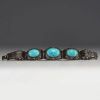 China - Solid openwork silver bracelet with two large turquoise stones.