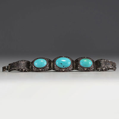 China - Solid openwork silver bracelet with two large turquoise stones.