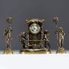 Auguste MOREAU (1834-1917) Gilt and silvered bronze clock and two candlesticks with putti decoration, signed Aug. Moreau, 19th century.