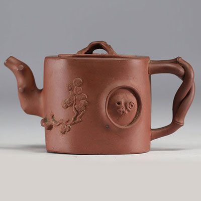 China - Yixing teapot in terracotta with floral decoration in relief, debossed mark on the underside.