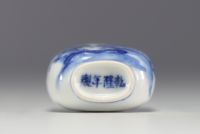 China - A blue-white porcelain snuffbox decorated with a figure, Qianlong mark under the piece.