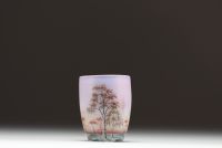 DAUM Nancy - Vase miniature en verre multicouche dégagé à l'acide et émaillé à décor de paysage lacustre et de bouleaux, signé sous la base.