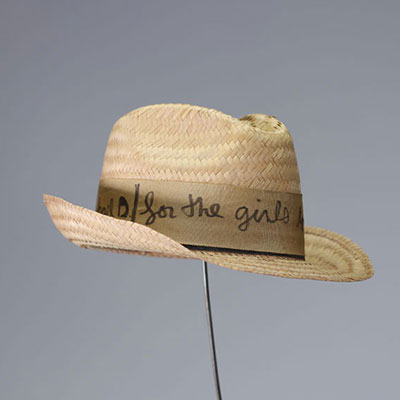 Straw hat with a fabric ribbon bearing a handwritten dedication in black marker by Ben Vautier: 'So that girls fall in love with Michael D., Ben 83.' Signed 'Ben' in marker on the ribbon.  Dimensions: