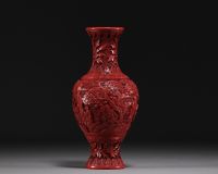 China - An antique cinnabar lacquer vase decorated with figures.