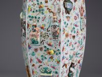 China - A rare pink family polychrome porcelain vase with relief decoration of domestic objects, fruit and floral motifs, hexagonal base, 19th century.