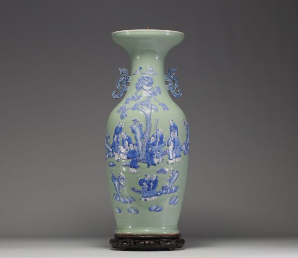China - Large celadon porcelain vase with relief decoration of figures and bats, 19th century.