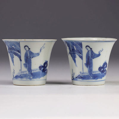 Pair of white and blue mugs decorated with  characters from the late 19th century