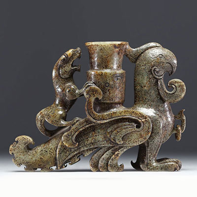 China - A patinated jade vase with a Phoenix design.