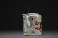 China - Porcelain teapot with dragon design, circa 1900.