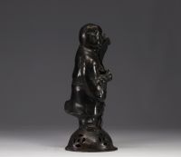 China - bronze sculpture of a young boy carrying a scroll.