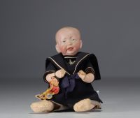 KAMMER and REINHARDT - Baby character sticking out his tongue, bisque head n°28, circa 1900.