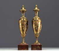 A pair of gilt bronze Directoire period covered vases.