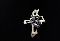 Christian LACROIX - Cross brooch, rhinestones and beige enamel on silver-plated metal, signed.