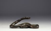 Patinated metal sculpture depicting a snake.