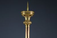 A large ormolu and chased bronze candlestick with a chalice decorated with a crown and leaves.