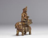 An ormolu Guanine sculpture resting on a lion from the Qing period (清朝)