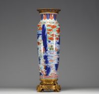 China - A polychrome porcelain vase with cloudy landscape and figures on a bronze frame, Transition period, 17th century.