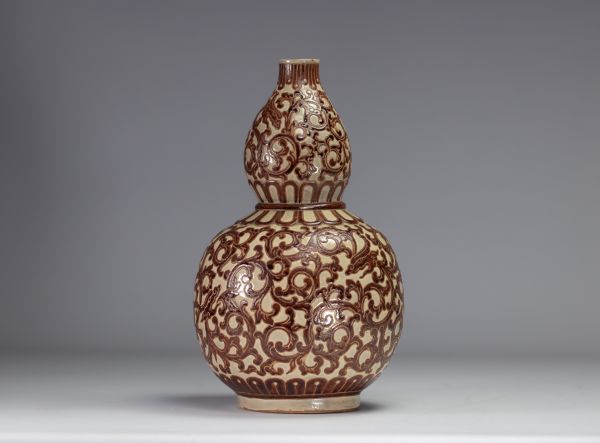 Indochina - ochre and green glazed ceramic gourd vase decorated with foliage, 1930