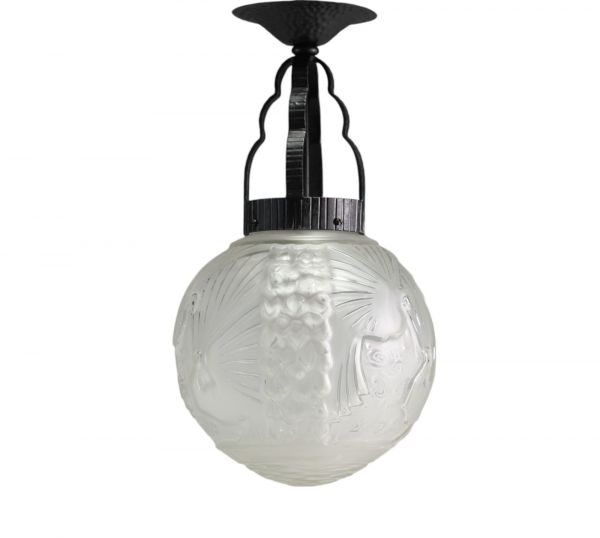 Art Deco pendant light in stylized glass with peacock decoration and hammered metal frame.