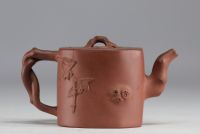 China - Yixing teapot in terracotta with floral decoration in relief, debossed mark on the underside.