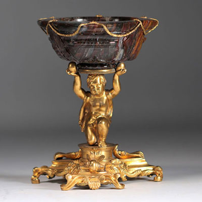 A gilded bronze bowl decorated with a child carrying a carved stone bowl