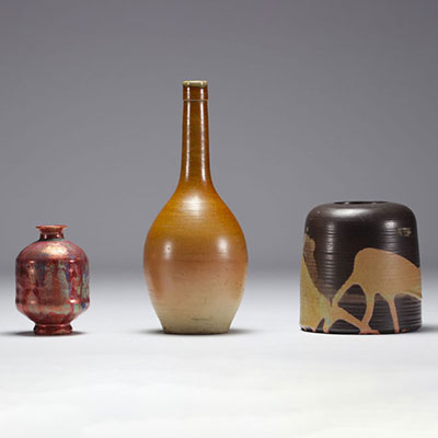 Set of three glazed ceramic pots, various markings.