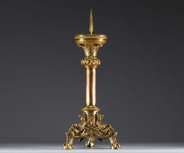 A large ormolu and chased bronze candlestick with a chalice decorated with a crown and leaves.