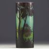 DAUM Nancy - Vase en verre multicouche dégagé à l'acide à décor d'arbres en bord d'étang, signé dans le décor.