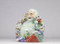 China - Porcelain Buddha surrounded by other small Buddhas, early 20th century.