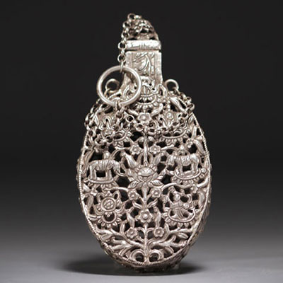 China - Carved silver incense bottle decorated with figures and elephants.